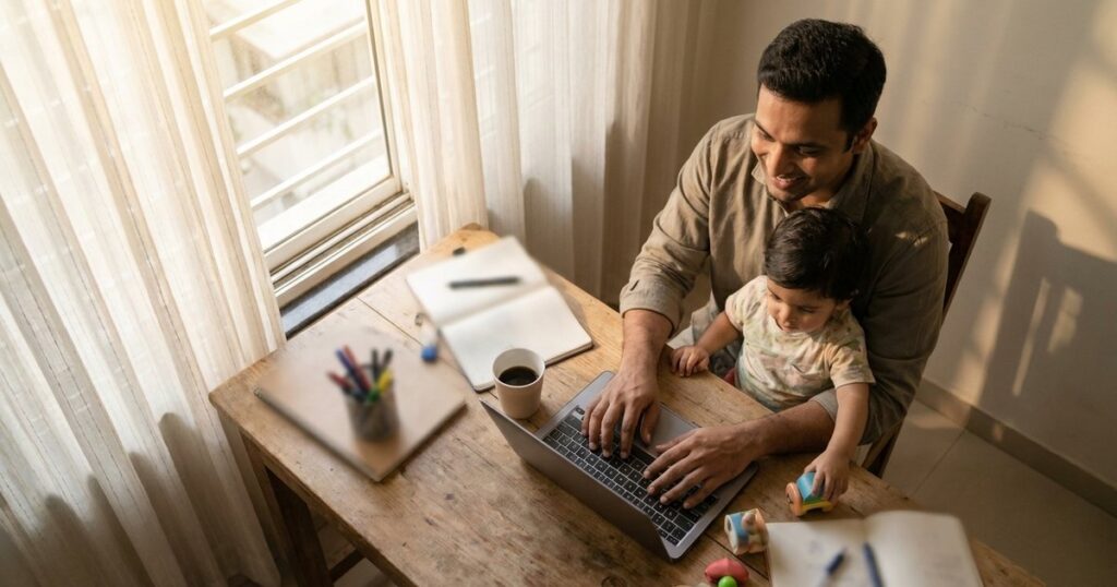An Indian entrepreneur in an office, with their child on their lap, balancing work and family life as the article explores.