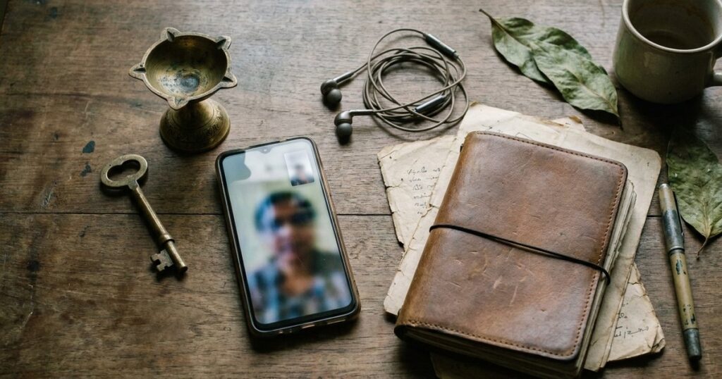 A desk with traditional Indian items and modern gadgets highlights strategies for team building without premature hiring.
