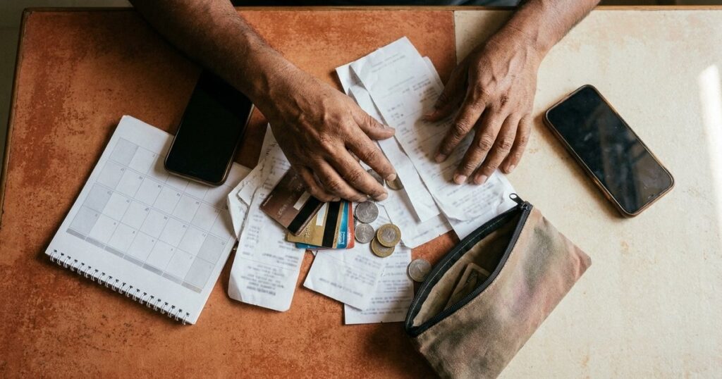 Overhead view of an Indian founder reviewing spending and calendar clues to uncover an implicit strategy