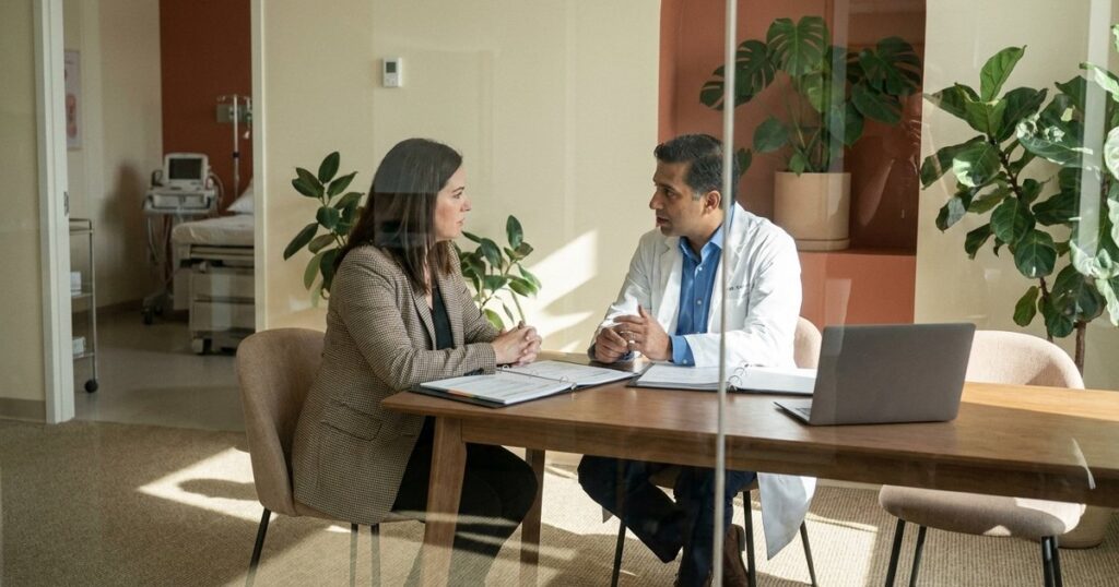 Doctor and financial consultant in discussion inside an IVF clinic, reflecting the theme of doctors as financial managers.