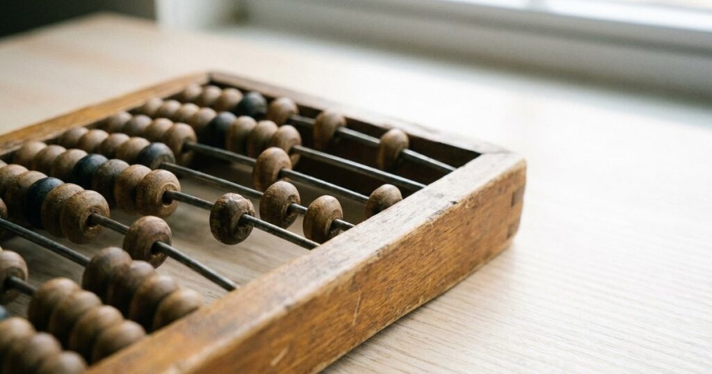 Close-up of an abacus on a wooden surface, reflecting the concept of costs and margins in startups.