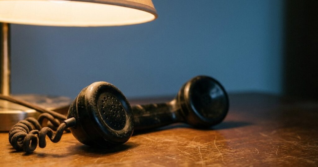Close-up of a vintage telephone handset on a desk, representing effective sales communication strategies.